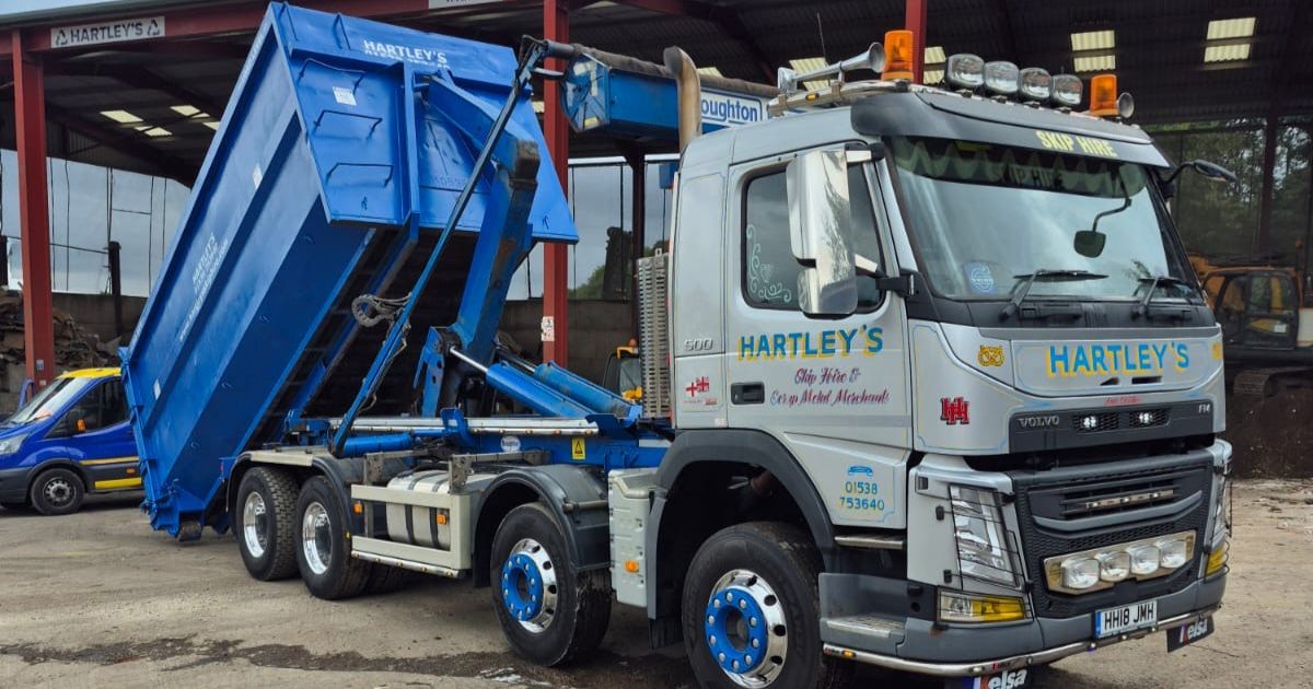 roll-on-roll-off-skip-removal Hartley's skip lorry unloading blue container