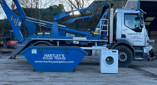 skip for hire next to a washing machine to show size comparison